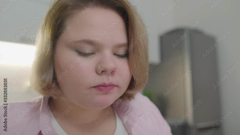 Overweight young woman eating pizza and drinking soda, unhealthy nutrition Overweight young woman eating pizza and drinking soda, unhealthy nutrition