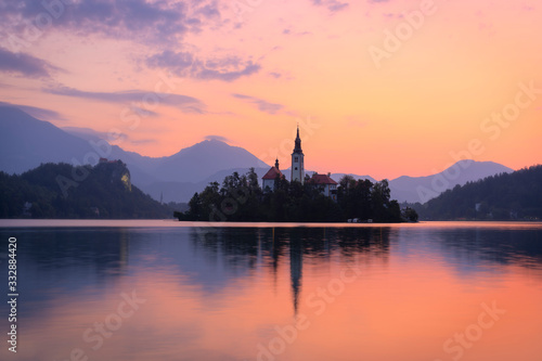 A beautiful colorful sunrise at Lake Bled in Slovenia. In the background you can see the Alps mountains. © jospannekoek