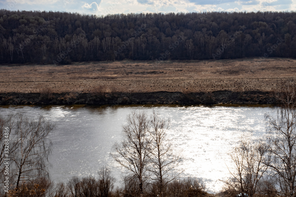 View of the Oka River in Russia in the spring in cloudy weather, beautiful river landscape.