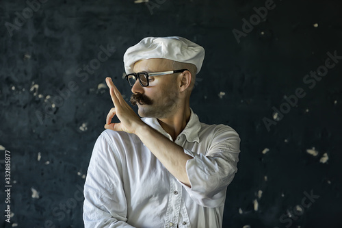stylish mustached hipster with glasses, cleans a classic jacket, can remove dust.