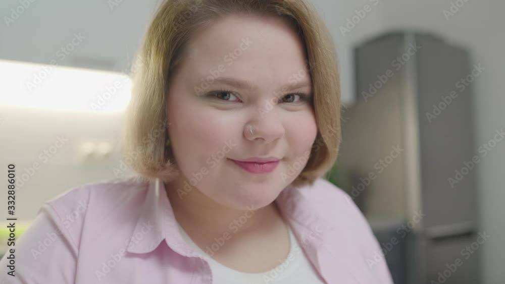 Young woman drinking orange juice and smiling at camera, health and beauty Young woman drinking orange juice and smiling at camera, health and beauty