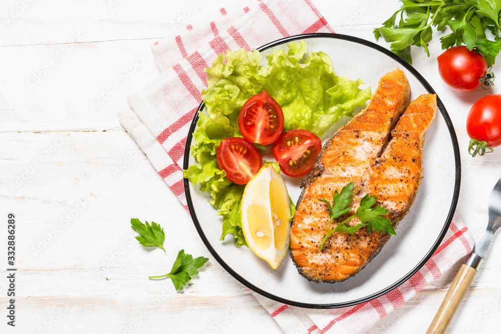 Grilled salmon fish steak on white. Grilled salmon fish steak on white.