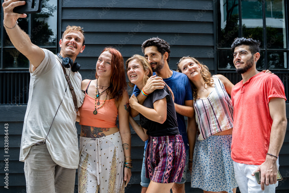 A group of friends of different ethnicities making a selfie in the street A group of friends of different ethnicities making a selfie in the street