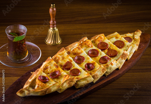 Hot Turkish pide pizza closeup on a wooden table. horizontal top view
