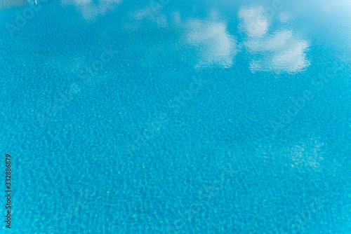 Clear blue water with sky reflection in a swimming Pool