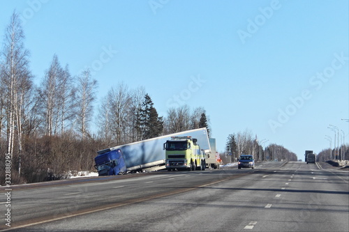 Obraz na płótnie Spring road accident, damaged truck in the roadside ditch on spring day, speed limit violation w salonie