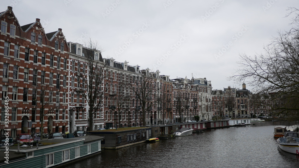 Gloomy Amsterdam row of houses on canal front