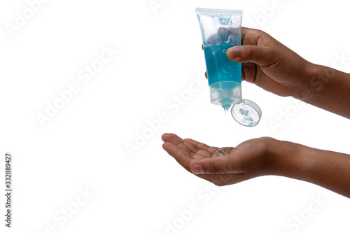 Child hand using hand skin sanitizer gel tube for washing hand isolated on white background. Health awareness for pandemic protection. - anti germ and preventative concept.