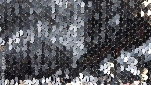 Metallic sequins, decoration changes its color when illuminated, beautiful abstract background with shimmer