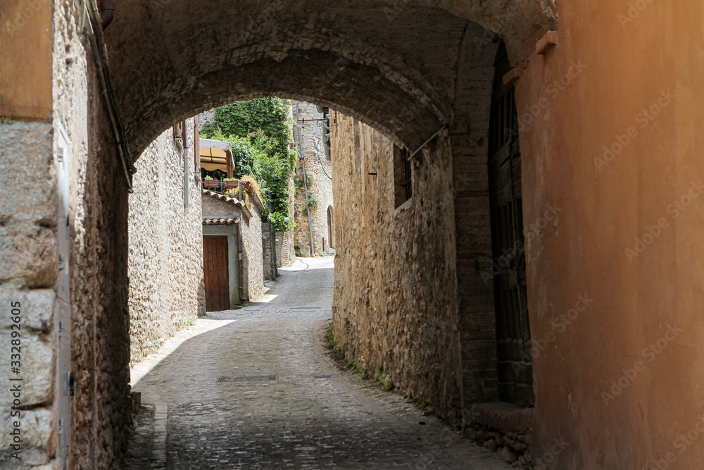 a narrow street with narrow passage to the church