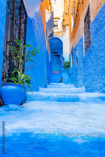 Narrow street in the blue city Chefchaouen, Morocco. Vertical. © ggfoto