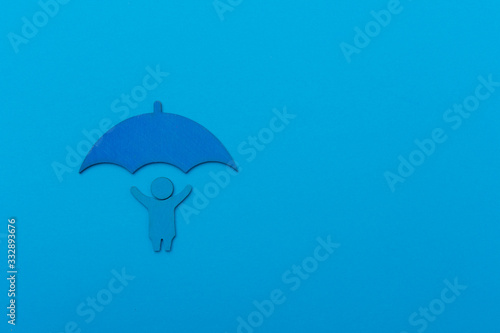 World Autism Awareness Day Concept. The child holds an umbrella on blue background
