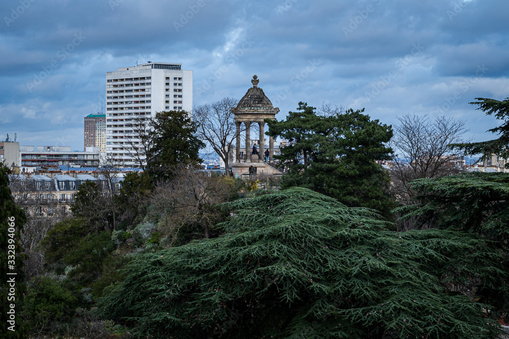 Beautiful view of Paris from the Buttes de Chaumont park under a cloudy sky