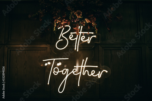 Better Together - neon sign on a brick wall in a restaurant at a wedding party. Love concept	