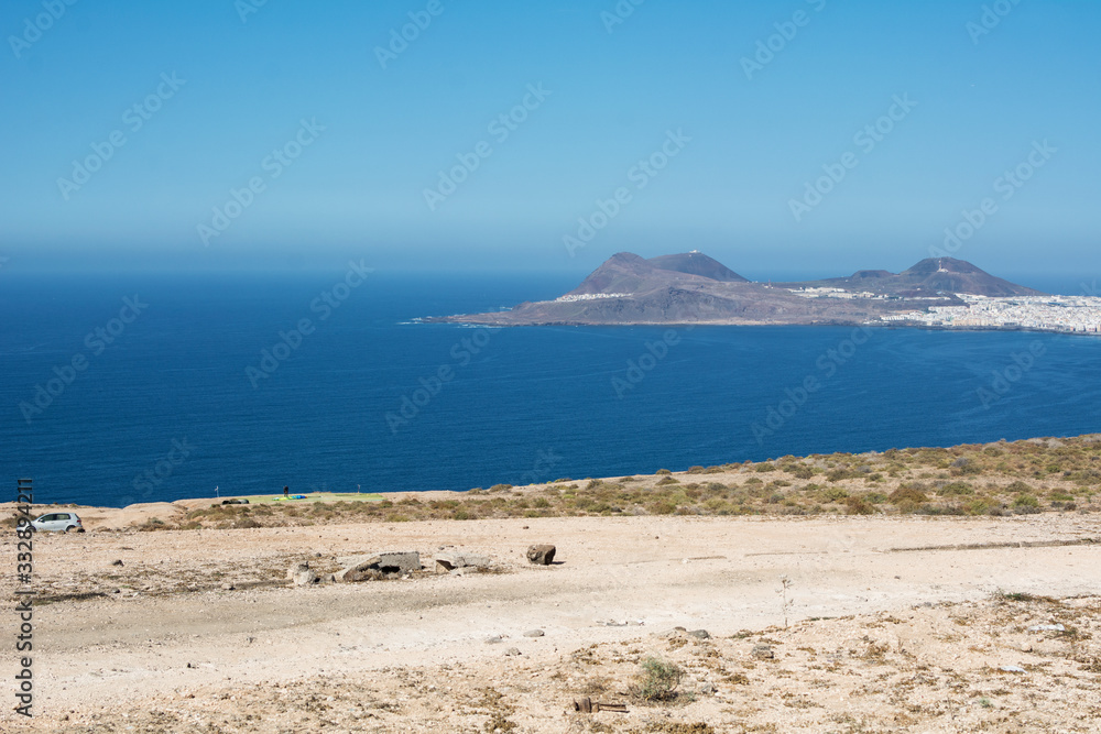 Part of the coast of an island, tropical landscape with a huge blue sea and the land illuminated by the summer sun.