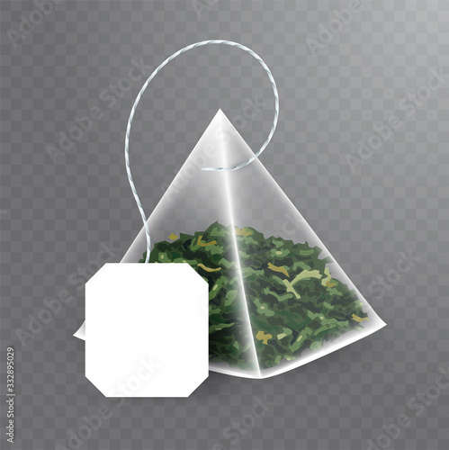 Pyramid shaped tea bag mock up with green tea inside. Vector realistic illustration of teabag with empty white label isolated on transparent background.