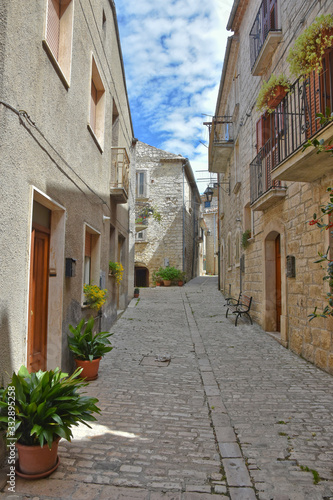 A narrow street between the old houses of the medieval village of Oratino  in Italy.