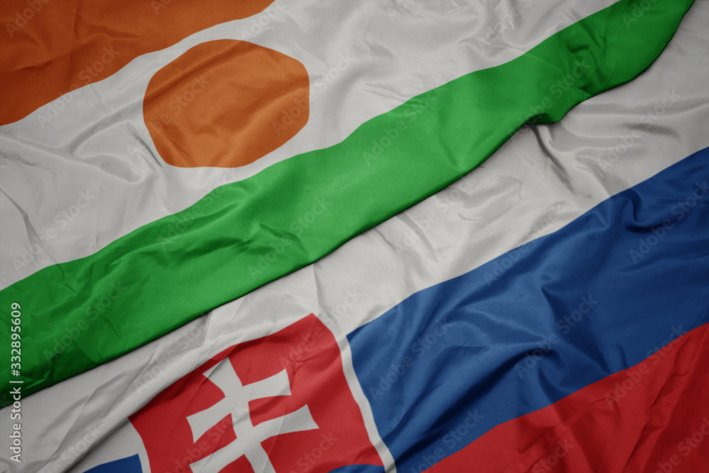 waving colorful flag of slovakia and national flag of niger.