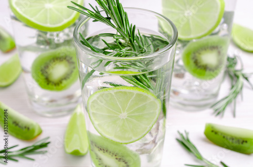 Transparent drink with fruit and rosemary