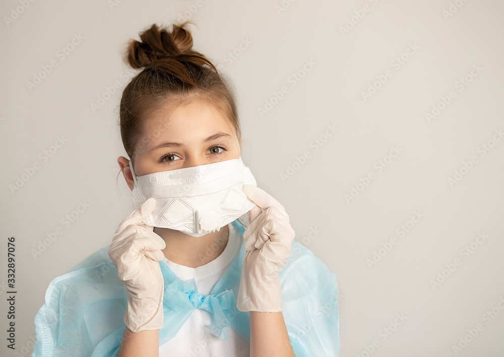 close-up teenager girl in surgical protective mask and rubber gloves on a neutral gray background. virus protection concept close-up teenager girl in surgical protective mask and rubber gloves on a neutral gray background. virus protection concept