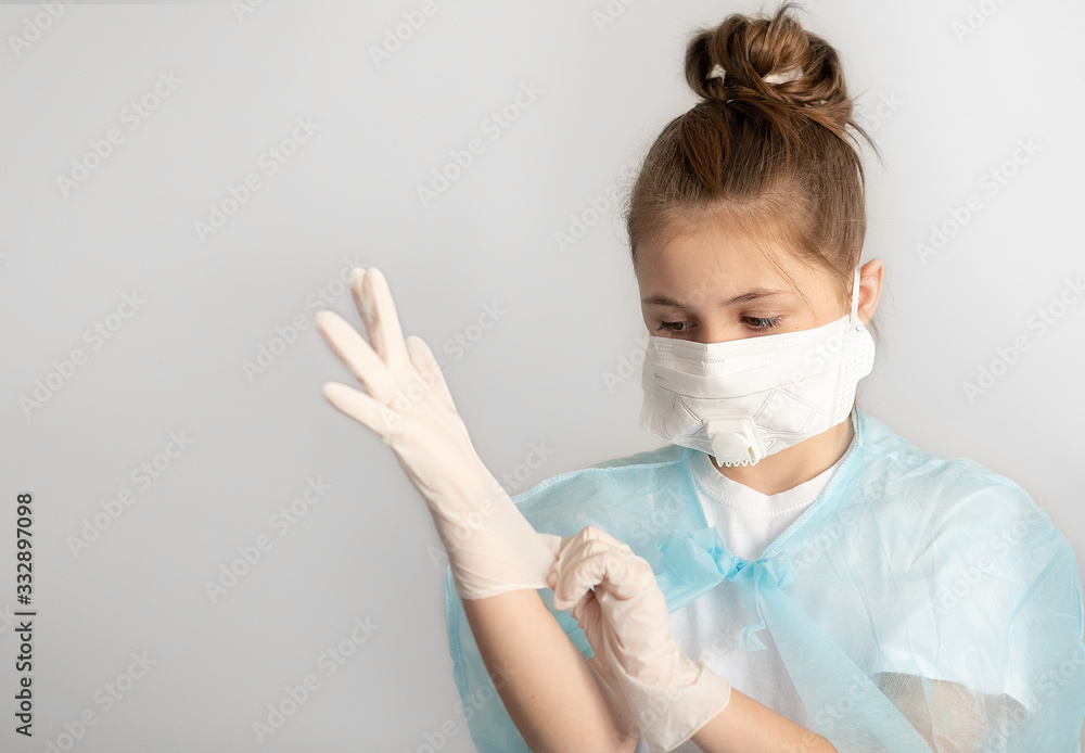 close-up teenager girl in surgical protective mask and rubber gloves on a neutral gray background. virus protection concept close-up teenager girl in surgical protective mask and rubber gloves on a neutral gray background. virus protection concept
