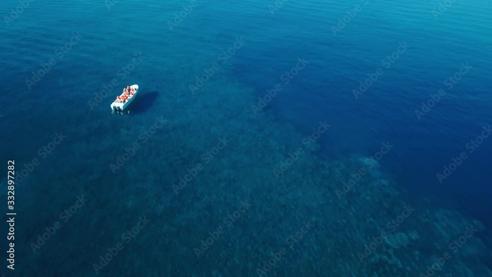 Boat full of tourist floating above coral reef Boat full of tourist floating above coral reef