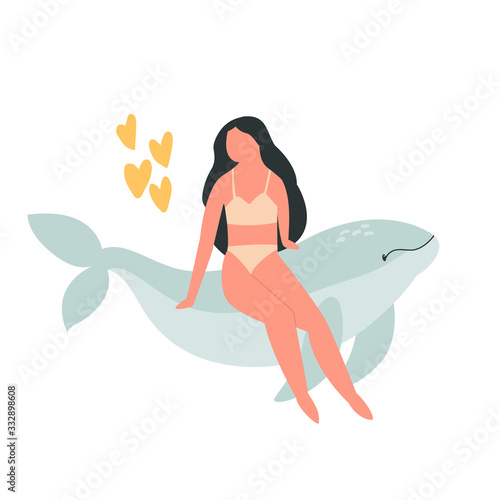 Young attractive girl sitting on a whale