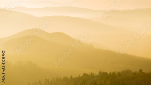 The misty orange mountains of Poland during sunset - wide shot