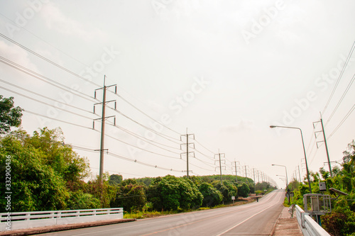 Vintage of electricity pole with green tree nature, Transmission line of electricity to rural
