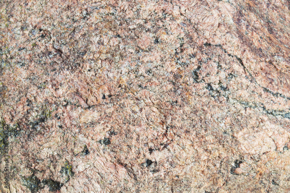 Natunal stone texture. Beige or pink granite surface with black splashes. Natunal stone texture. Beige or pink granite surface with black splashes.