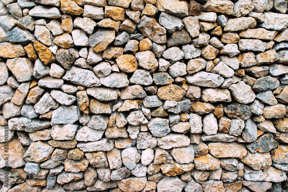 Part of a beige stone wall texture, for background close up. Part of a beige stone wall texture, for background close up.