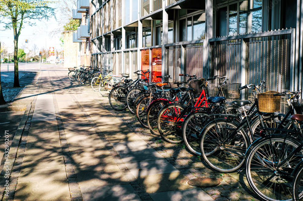 A lot of bicycles are parked on a city street. Eco life, contemporary lifestyle.