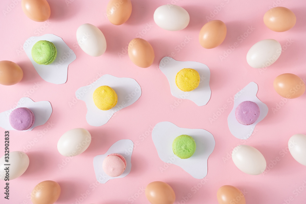 Creative layout made with colorful Easter eggs and macarons. Minimal pink pattern background. Spring holidays concept. Creative layout made with colorful Easter eggs and macarons. Minimal pink pattern background. Spring holidays concept.