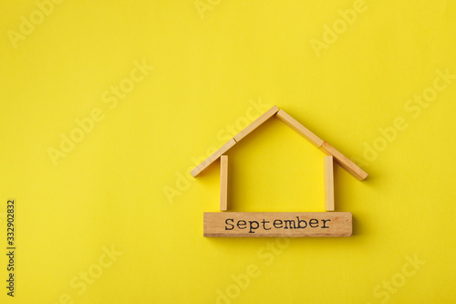 house shaped wooden logs on the yellow background