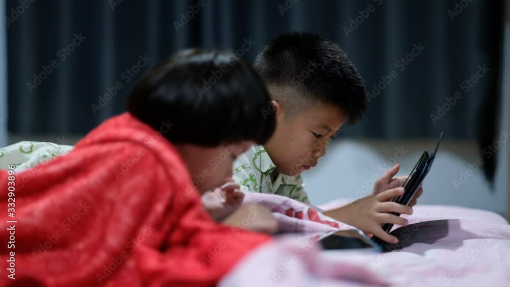 two chinese children addicted tablet, asian child watching tablet, kid use telephone together on their bed, play phone, kid addict smartphone
two chinese children addicted tablet, asian child watching tablet, kid use telephone together on their bed, play phone, kid addict smartphone