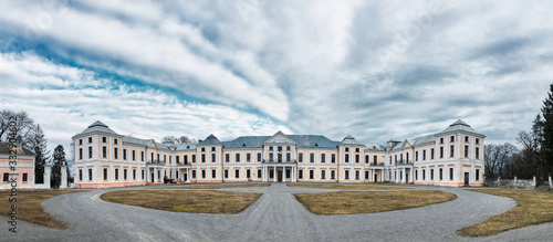 Vyshnivets/Ukraine:1 Mar 2020 - Panoramic picture of old Vyshnivets palace in winter early spring autumn with blue sky and white clouds. Historical park landscape with landmark. National heritage.