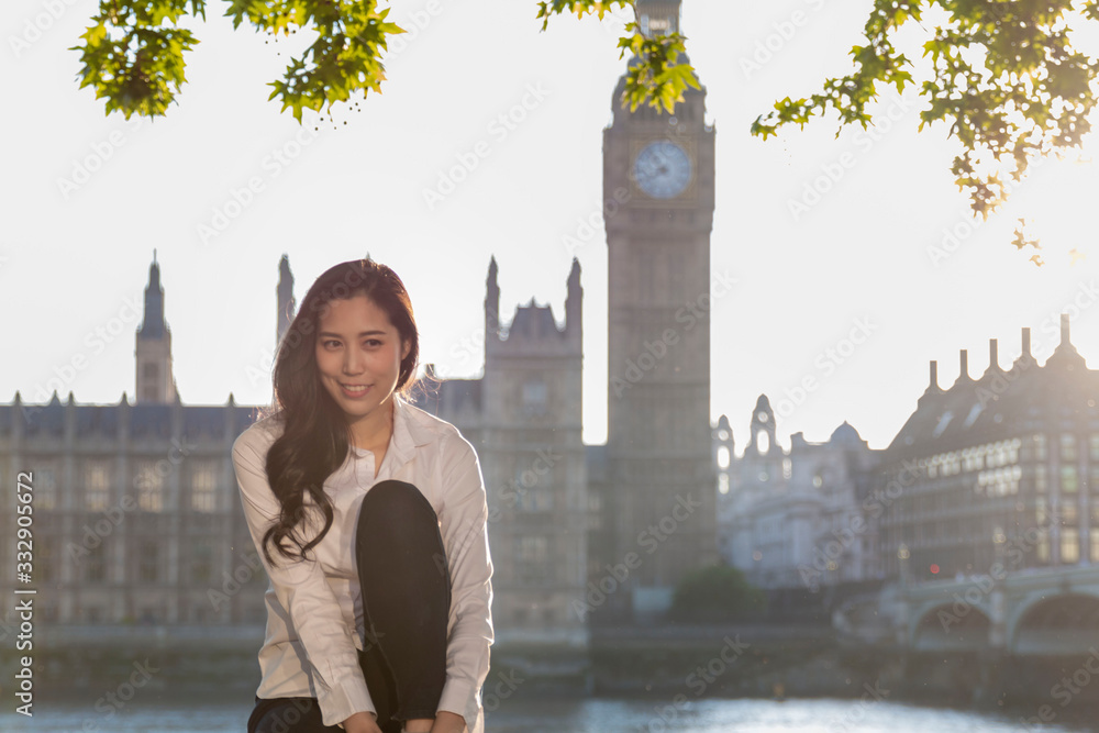 Asian business women near Big Ben, London, England. Girl in London during winter near Westminster bridge, London. oung female travel  in London, England. Beautiful young Asian girl. 
