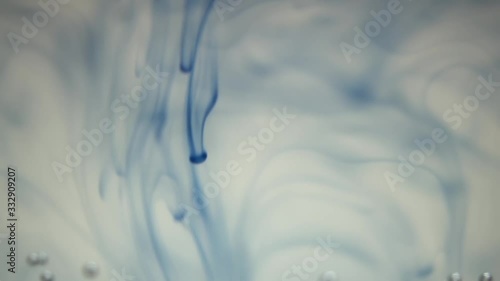 Blue ink sliding down the water photo