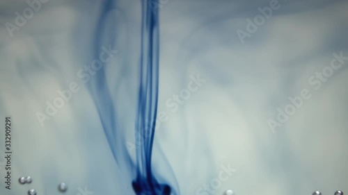 Blue ink sliding down the water photo