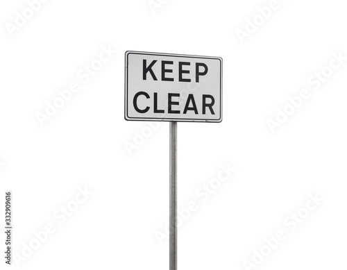 eep clear. Caution sign on a metal pole isolated