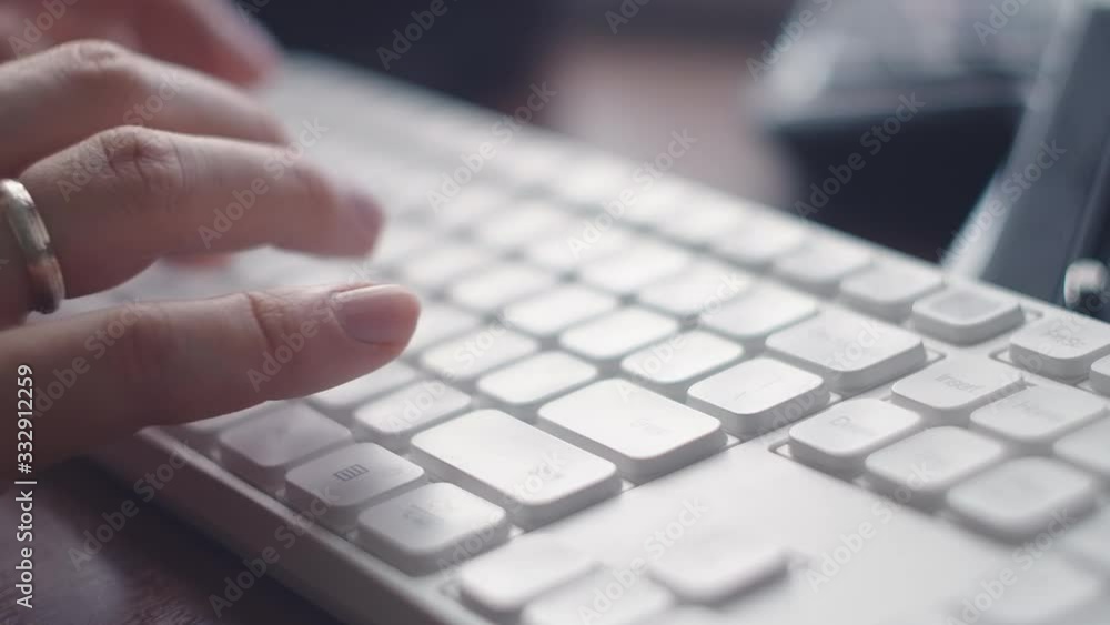 Working on laptop computer, typing on keyboard, modern office business. Men's hands in a beige sweater print on the keyboard in light office. Close-up. Sending email Working on laptop computer, typing on keyboard, modern office business. Men's hands in a beige sweater print on the keyboard in light office. Close-up. Sending email