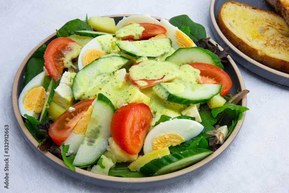 Egg, Feta, and some vegetable salad like cucumber, tomato and potato Egg, Feta, and some vegetable salad like cucumber, tomato and potato
