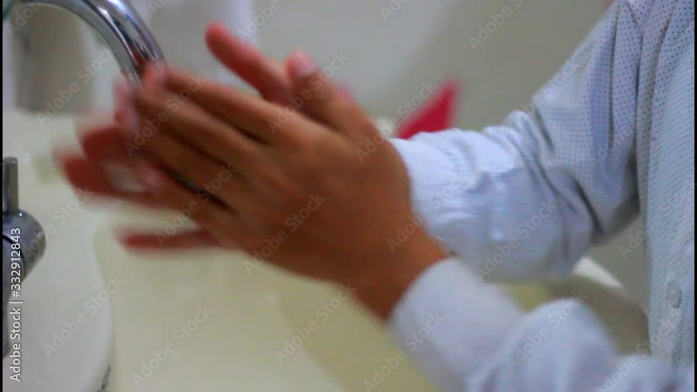 Child Washing His Hands at the Bathroom With Water,, Soap and Foam. It's important to wash hands in order to avoid virus like corona virus. Cleaning the skin and have water flowing through the hand. Child Washing His Hands at the Bathroom With Water,, Soap and Foam. It's important to wash hands in order to avoid virus like corona virus. Cleaning the skin and have water flowing through the hand.