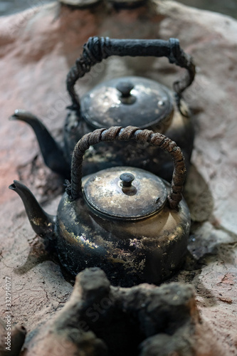 old kettle with smoke in camping outdoor