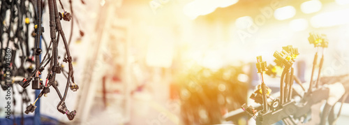 Bunch of wiring harnesses. Automobile industry theme, wide-angle industrial background with copy space, light effect