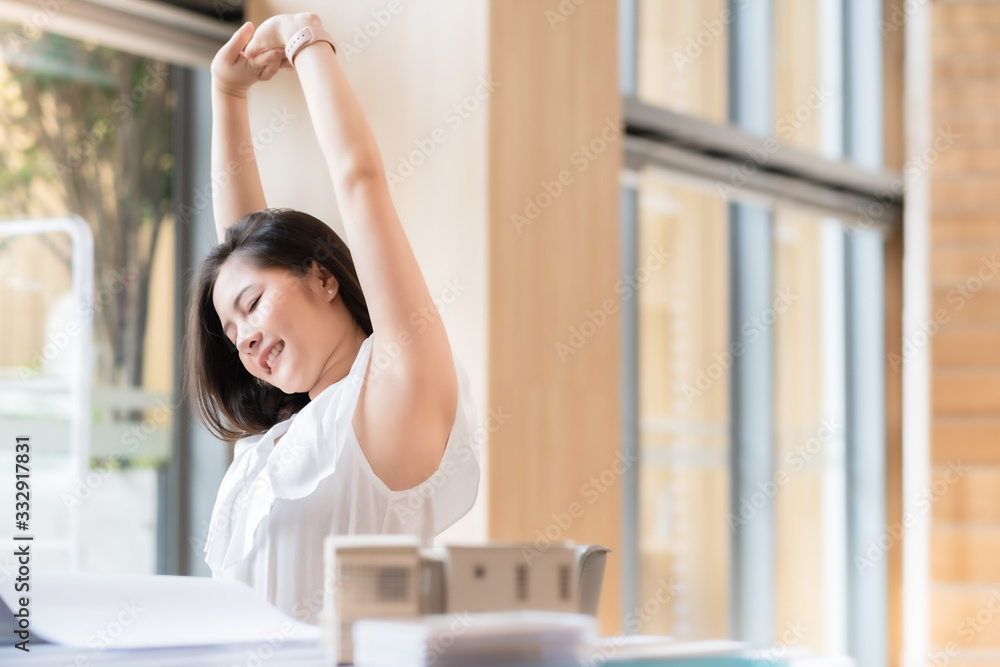 Business Asian woman relaxing with hands behind her head and sitting on an office chair.Time to relax. Business Asian woman relaxing with hands behind her head and sitting on an office chair.Time to relax.