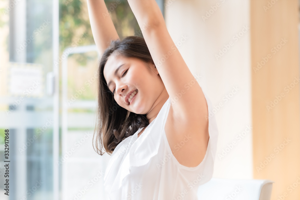 Business Asian woman relaxing with hands behind her head and sitting on an office chair.Time to relax. Business Asian woman relaxing with hands behind her head and sitting on an office chair.Time to relax.
