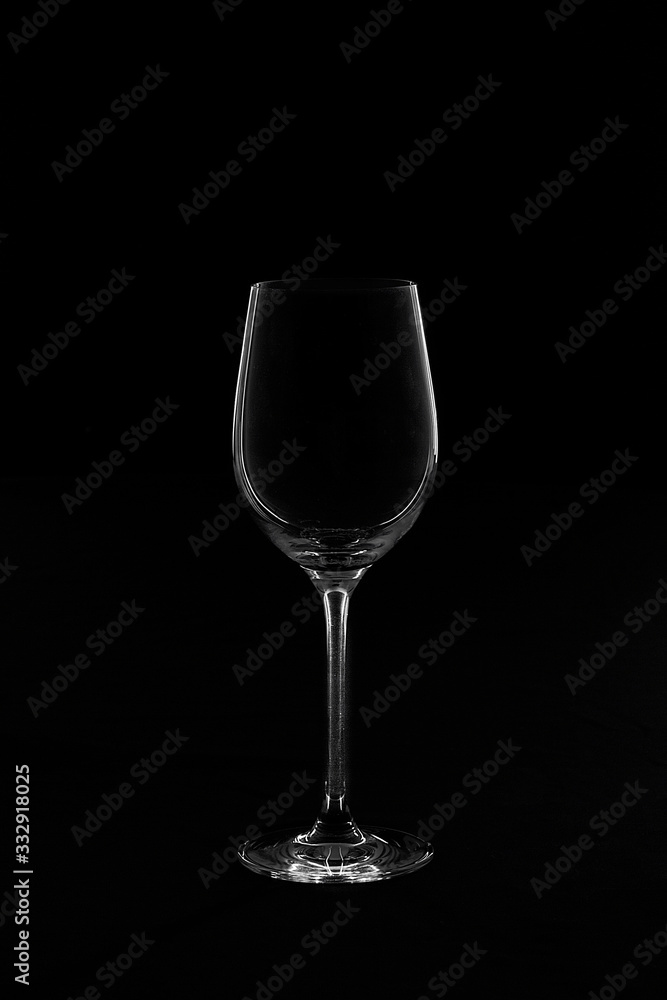 Empty transparent wine glass in ther black and white background Empty transparent wine glass in ther black and white background