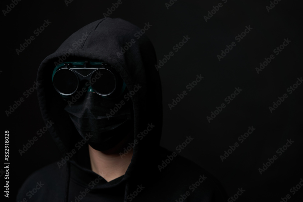 Young man wearing face mask and protective glasses. Young man wearing face mask and protective glasses.