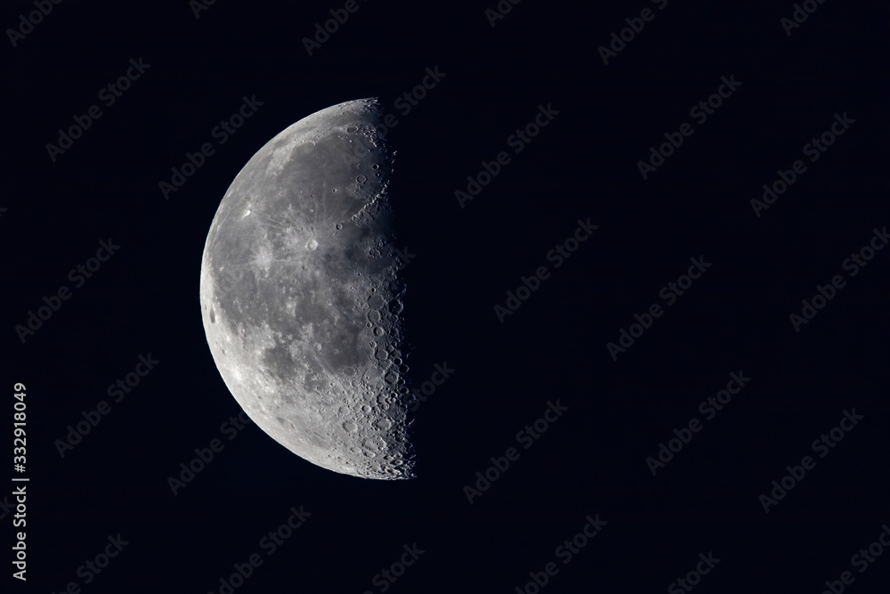 An early morning moon in partial shade